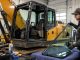JCB excavator cab glass replacement in a construction equipment repair workshop