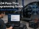 Technician performing J2534 pass thru ECU programming with OEM software and regulated battery support